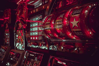 A red slot machine in an arcade.