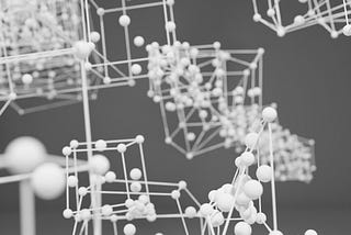 The image depicts a three-dimensional molecular structure model. It consists of interconnected spheres and rods, representing atoms and bonds, respectively. The spheres are likely to symbolize different atoms, while the rods illustrate the chemical bonds between them. The structure appears complex, with multiple layers and connections, suggesting a detailed representation of a molecular or crystalline lattice. The grayscale color scheme emphasizes the geometric and spatial relationships.