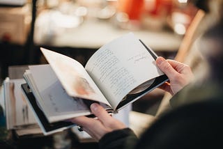 Woman looking at info on a CD book.