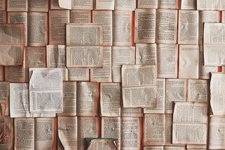 A surface entirely of open books facing us.