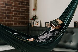 Millennial sits in hammock contemplating existential dread during 2020 quarantine