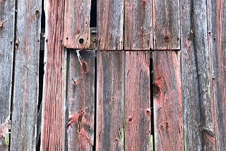 Rustic barn siding with red and gray hues