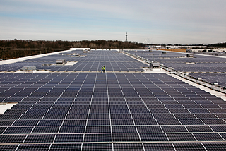 The expansive solar rooftop of an Amazon facility