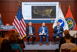 The FAA’s Thomas Draffen (at podium) is joined by fellow aviation representatives on a panel focused on improving air traffic telecommunications. (Photo: DOT)