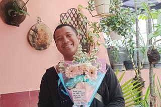 Me with holding flowers.