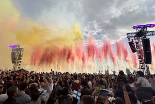 At the Old Port in Marseille, France. A huge crowd with their cameras in the air. The colors streams in the air are red and yellow.