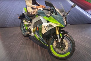A view of the Kemper RC electric sportbike from Yadea with a female model sitting atop it.