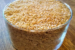 Cooking long grain brown rice in a pot with a tight-fitting lid.