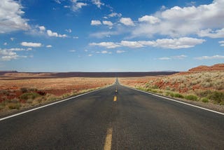 A picture of a straight road fading in the horizon