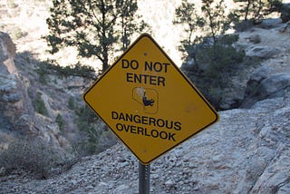 A sign on the Centennial trail that reads: Do Not Enter, Dangerous Overlook.