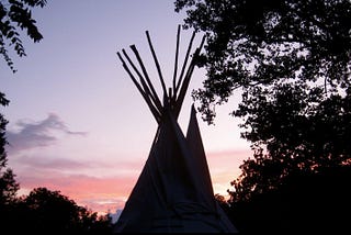A tipi against the sunset.