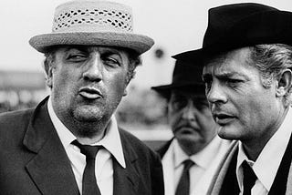 Photo: Italian director Federico Fellini (left) and actor Marcello Mastroianni (right)