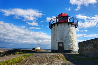 Small white squat white lighthouse with red top. Burry Port, Llanelli, Carmarthenshire, Wales.