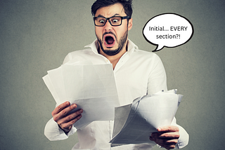 Man in glasses looking shocked while holding thick stack of papers