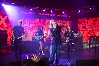 Colored photograph by Kevin Mazur/Getty Images for DG. Violet Grohl, Dave Grohl, Beck, St. Vincent, Krist Novoselic and Pat Smear perform onstage during The Art of Elysium and We are Here Present Heaven is Rock and Roll at Hollywood Palladium on Jan. 4, 2020 in Los Angeles.