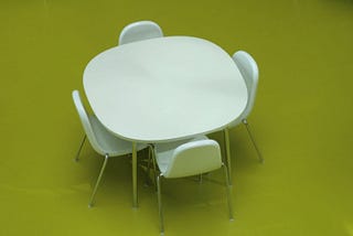 Lunchroom table with four chairs.