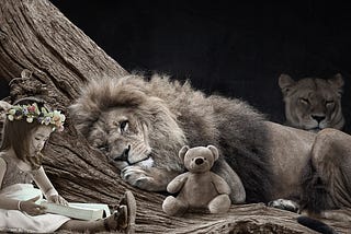 A little girl, sitting under a tree, reading a book to her friends, which consists of a male lion, with a stunning mane, a female tiger and her best friend in all the world, her teddy bear.