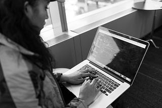 A woman typing on a laptop.