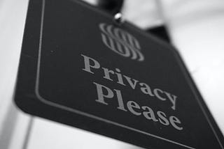 Photo of a doorway sign that reads “Privacy Please”