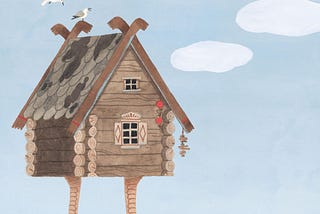 A wooden house with chicken legs stands on a beach.