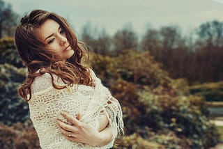A beautiful woman in white knit sweater
