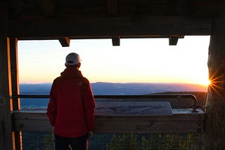 Man looking at sunrise by Matthias Münning on Unsplash