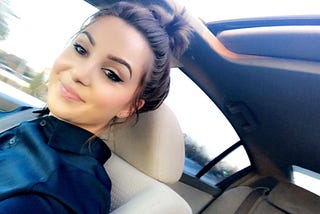 Picture of Rebecca Materasso sitting in a vehicle.