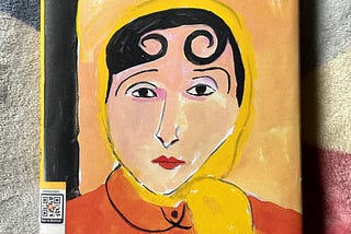 Portrait of a woman in yellow headscarf and orange jacket