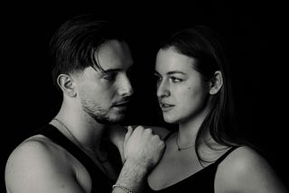 A man and a woman looking contemplatively at one another