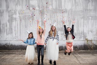 Four children celebrating New Year’s Eve.