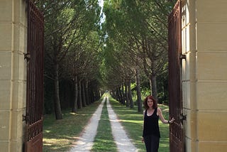 Author at the gate of a chateau in France