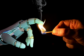 Human holding a match to a robot hand. This is meant to be a figurative display of people fighting back against AI taking over their jobs.