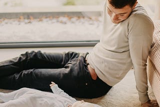 Father looks at infant child while taking time off from work