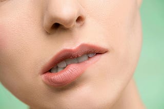Woman biting her lower lip