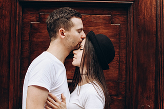 A boy kissing a girl