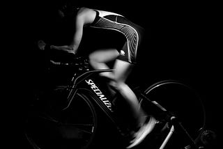 Cyclist on a time trial bike in black and white photograph