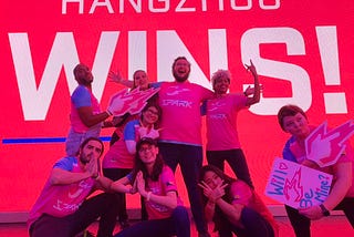 A group of fans celebrating the win of the Hangzhou Spark at the Blizzard Arena; Hangzhou Wins on the screen in the background