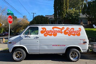 White van parked in the street with Depressed Express painted on the side.