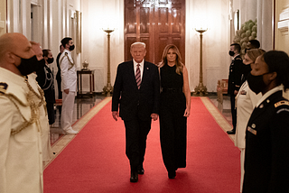 Donald and Melania trump walking down red carpet