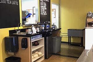 diner coffee station behind serving counter, blackboard menu backsplash