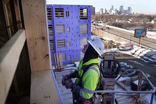 Carpenter Paul Olson, a new apprentice in construction, works to install exterior sheet rock on an apartment complex in Minneapolis, Minnesota, March 14, 2023. Photo by Anthony Souffle/TNS/ABACA via Reuters