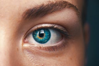 Close-up of a woman’s blue eye.