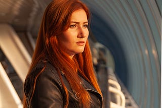 Woman with red hair staring into the distance — Picture from Depositphotos.com