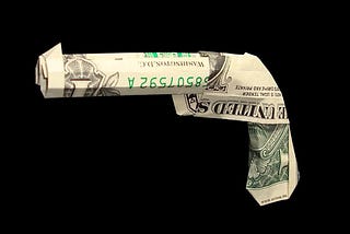 dollar bills folded into the shape of a pistol