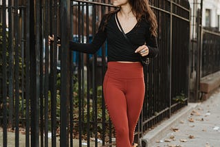 A woman closing the gate to her home before beginning the day.