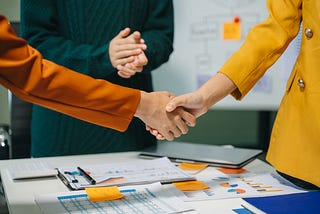 Two confident business man shaking hands during a meeting in the office