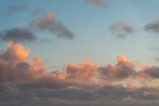 A sky pink and blue sky during sunrise depicting the new start of a day