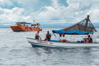 two Open Blue boats around a mariculture fish farm pen for cobia