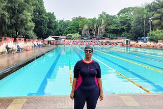 Author’s photo in a swimsuit, captured against the backdrop of a swimming pool