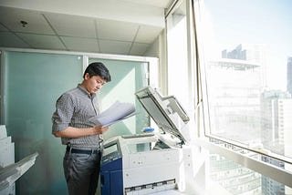 man using a copier machine